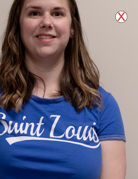 A headshot of a woman wearing a SLU t-shirt. The photo is poorly cropped, cutting off the top of her head and her entire left side.