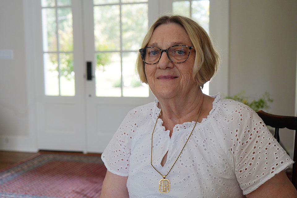 Carrie Sherman A woman poses for a photo in her home.
