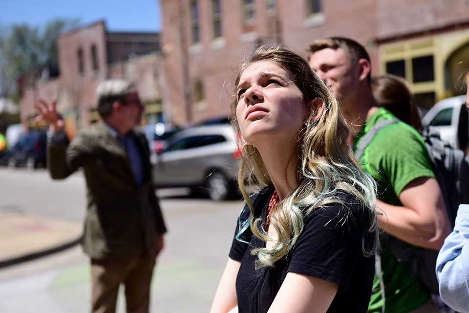 An American studies student look at a building during a tour.