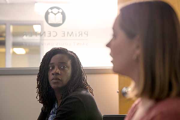 A student looks on as another student speaks in a SLU classroom.