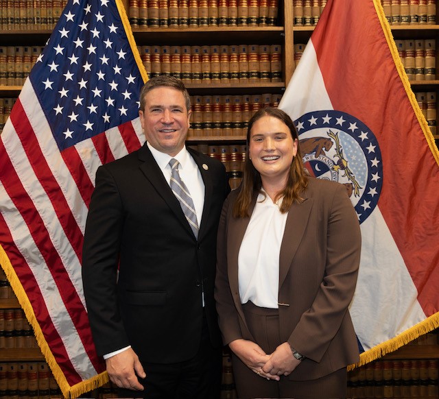 Paige Mitchell stands next to Missouri Attorney General Andrew Bailey