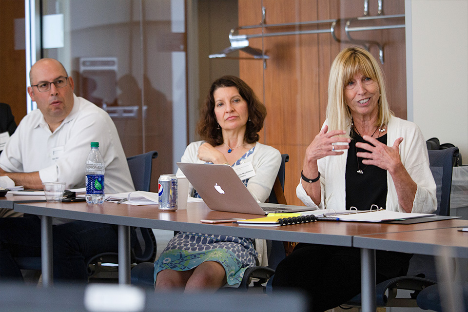 Prof. Sidney Watson speaking with two others