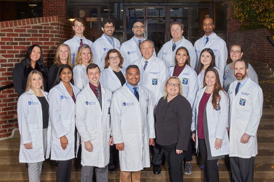 15 members of the SSM Vascular Group stand on a set of steps