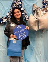 Sara Mosavi Sara Mosavi stands next to star-shaped balloons, holding a sign that reads "I am a BIlliken"