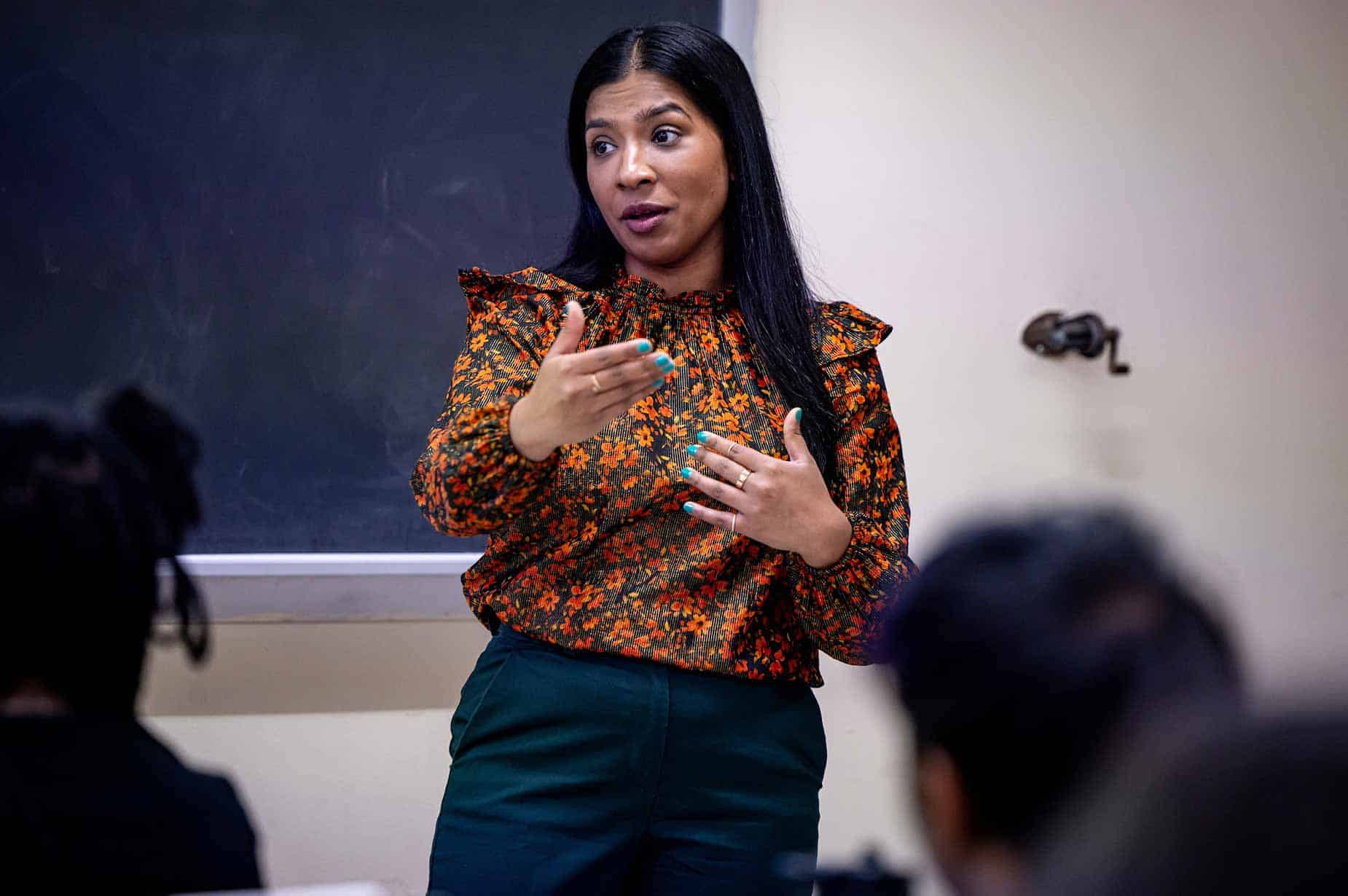 A female professor delivers a lecture to her class